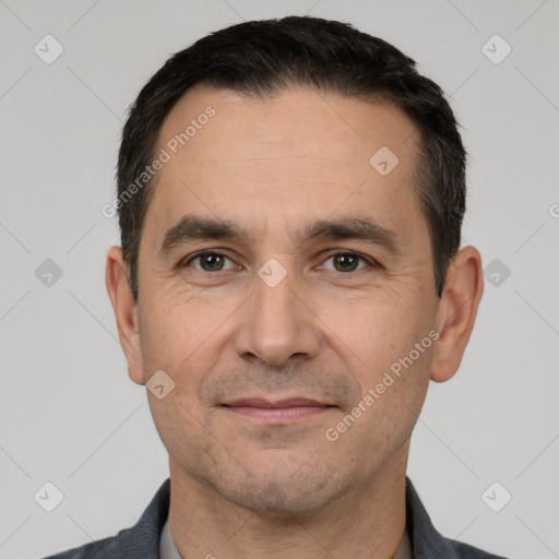 Joyful white adult male with short  black hair and brown eyes