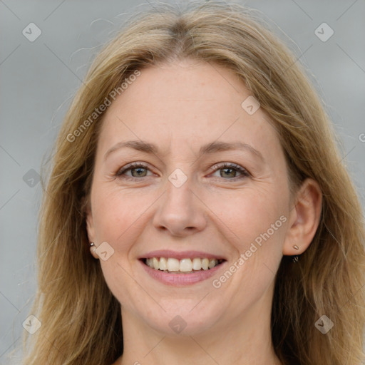 Joyful white adult female with long  brown hair and grey eyes