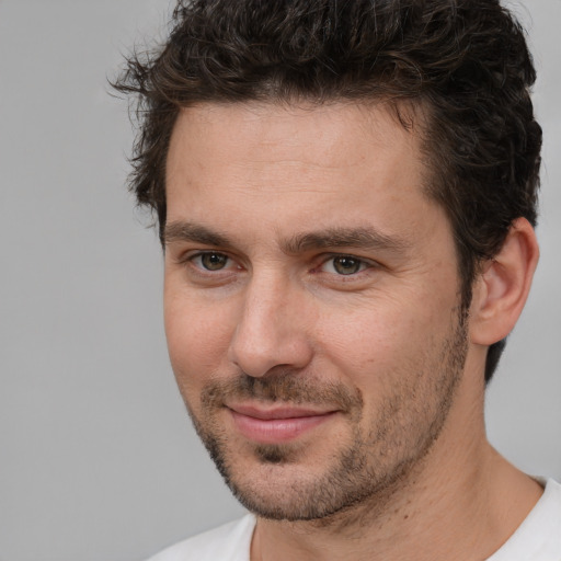 Joyful white adult male with short  brown hair and brown eyes