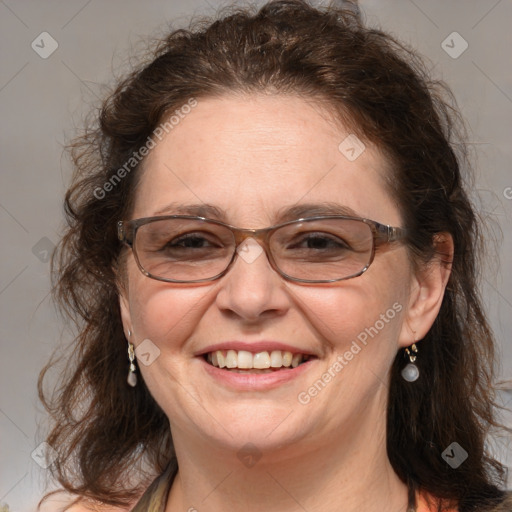 Joyful white adult female with medium  brown hair and blue eyes