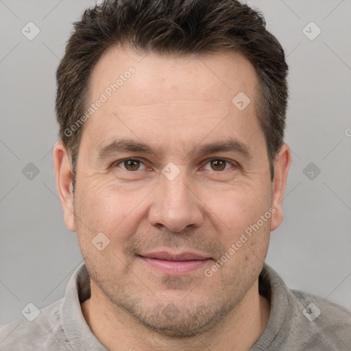 Joyful white adult male with short  brown hair and brown eyes