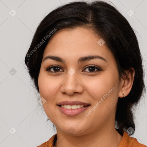 Joyful latino young-adult female with medium  brown hair and brown eyes