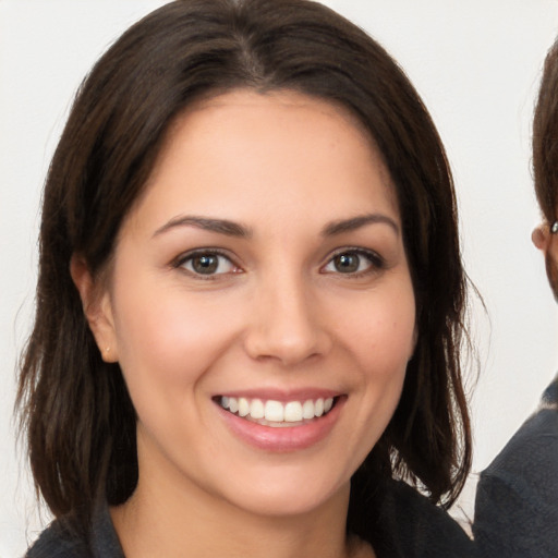 Joyful white young-adult female with medium  brown hair and brown eyes