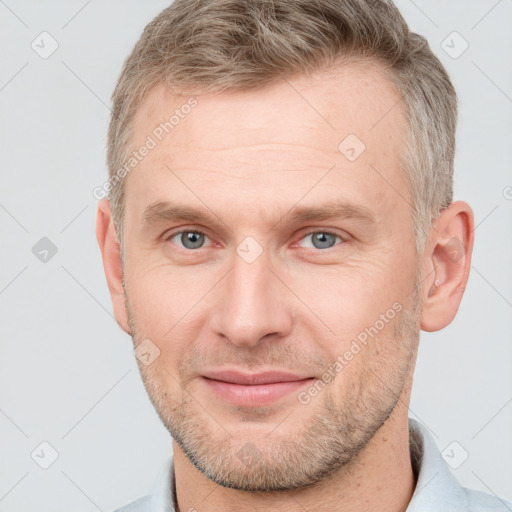 Joyful white adult male with short  brown hair and grey eyes