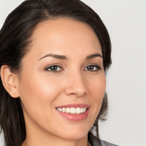 Joyful white young-adult female with long  brown hair and brown eyes