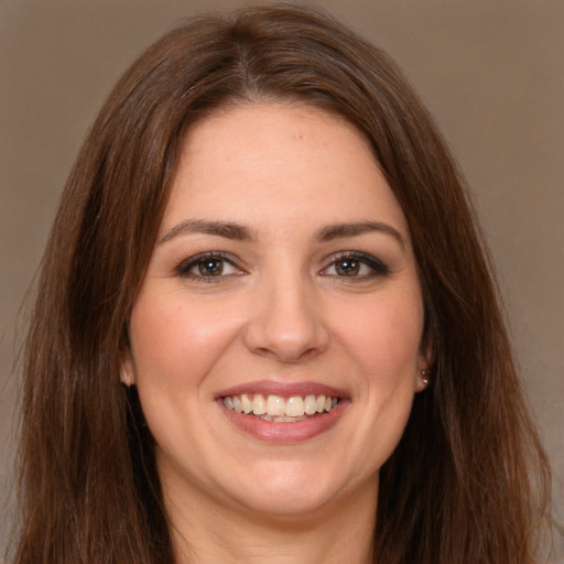 Joyful white young-adult female with long  brown hair and brown eyes