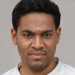 Joyful latino young-adult male with short  brown hair and brown eyes