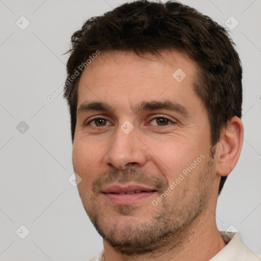 Joyful white adult male with short  brown hair and brown eyes