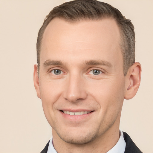 Joyful white adult male with short  brown hair and grey eyes