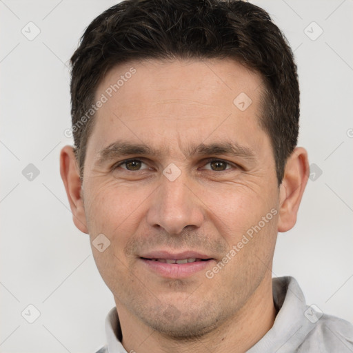 Joyful white adult male with short  brown hair and brown eyes