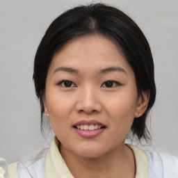 Joyful asian young-adult female with medium  black hair and brown eyes