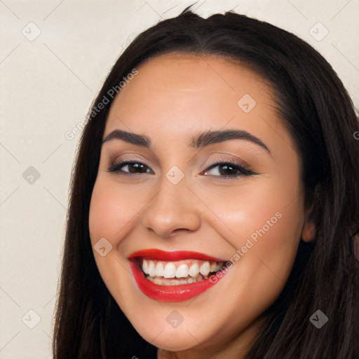 Joyful white young-adult female with long  black hair and brown eyes