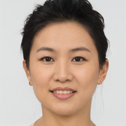 Joyful asian young-adult female with short  brown hair and brown eyes