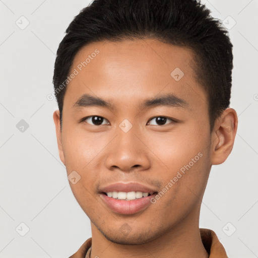 Joyful asian young-adult male with short  brown hair and brown eyes