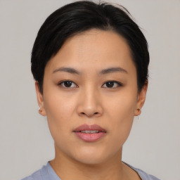 Joyful asian young-adult female with short  black hair and brown eyes