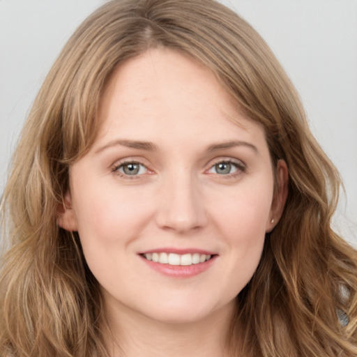 Joyful white young-adult female with long  brown hair and grey eyes