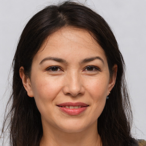 Joyful white adult female with long  brown hair and brown eyes