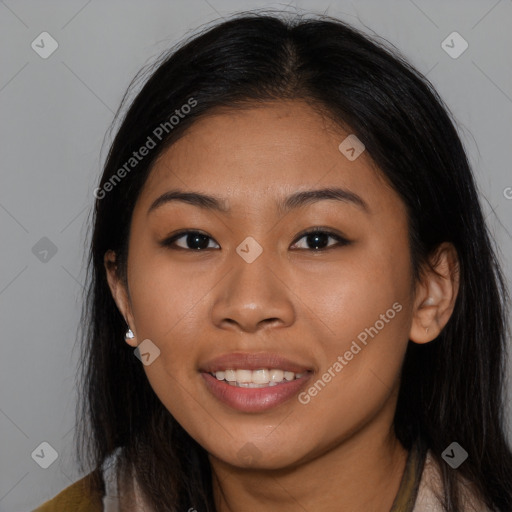 Joyful latino young-adult female with long  brown hair and brown eyes