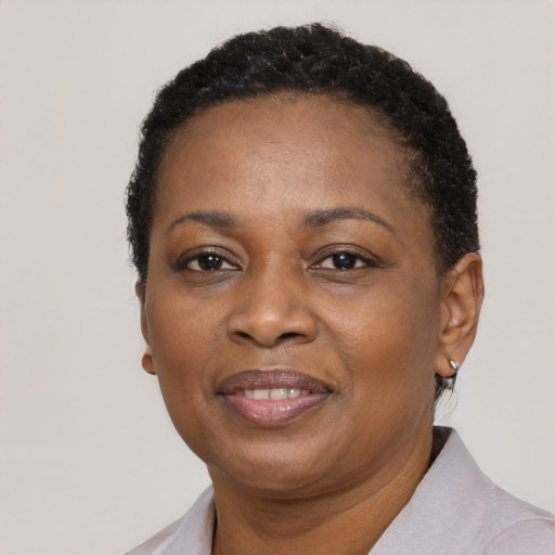 Joyful black adult female with short  black hair and brown eyes