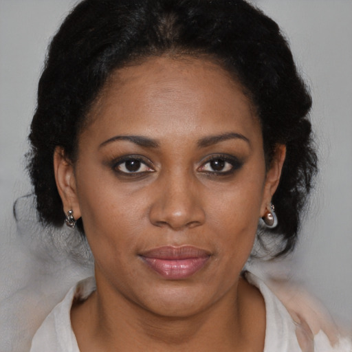 Joyful black adult female with medium  brown hair and brown eyes