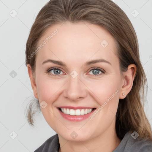 Joyful white young-adult female with medium  brown hair and grey eyes