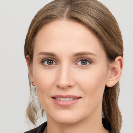 Joyful white young-adult female with long  brown hair and grey eyes