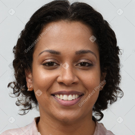 Joyful black young-adult female with long  brown hair and brown eyes