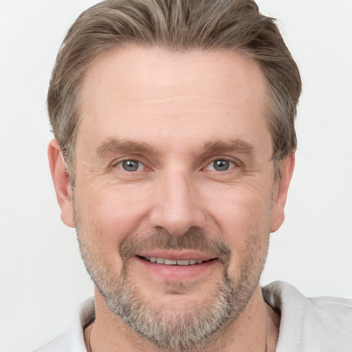 Joyful white adult male with short  brown hair and grey eyes