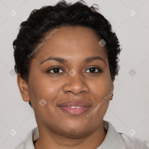 Joyful black adult female with short  brown hair and brown eyes