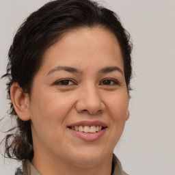 Joyful white adult female with medium  brown hair and brown eyes