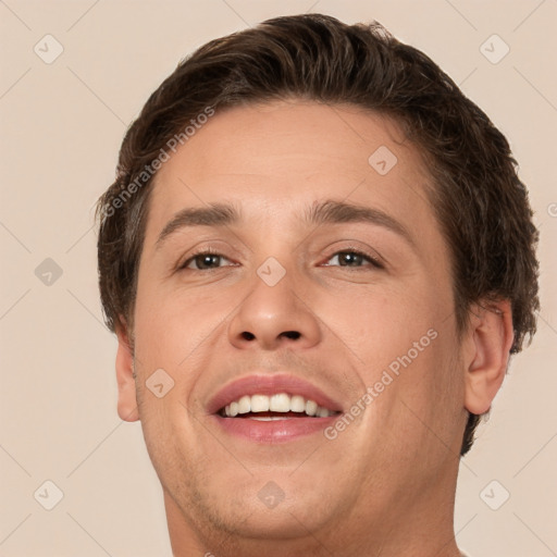 Joyful white adult male with short  brown hair and brown eyes