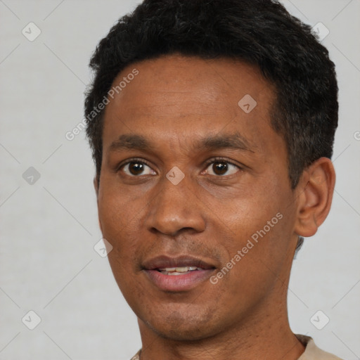 Joyful black adult male with short  black hair and brown eyes