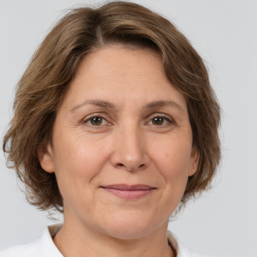 Joyful white adult female with medium  brown hair and brown eyes