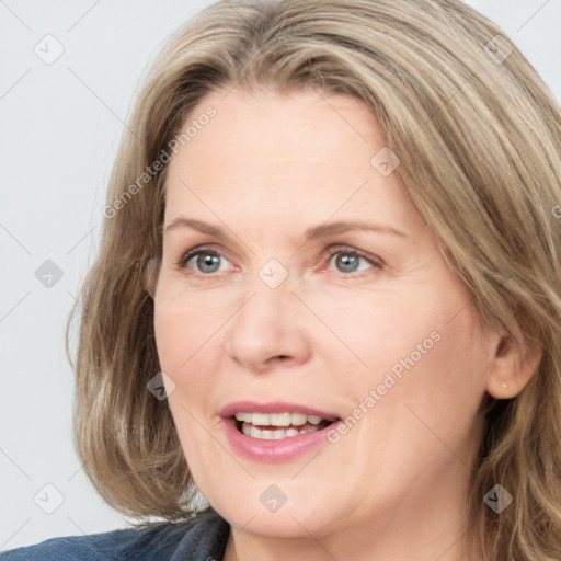 Joyful white adult female with medium  brown hair and blue eyes