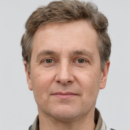 Joyful white adult male with short  brown hair and grey eyes