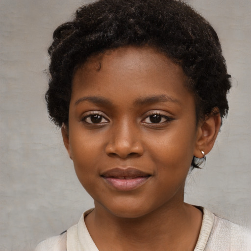 Joyful black child female with short  brown hair and brown eyes