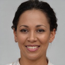 Joyful latino young-adult female with short  brown hair and brown eyes