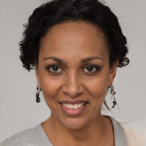 Joyful black adult female with short  brown hair and brown eyes