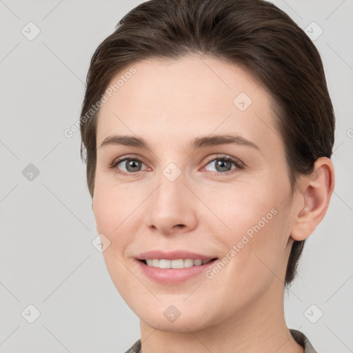 Joyful white young-adult female with short  brown hair and grey eyes