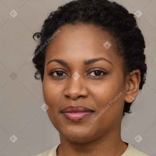 Joyful black young-adult female with short  brown hair and brown eyes