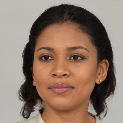 Joyful black young-adult female with medium  brown hair and brown eyes