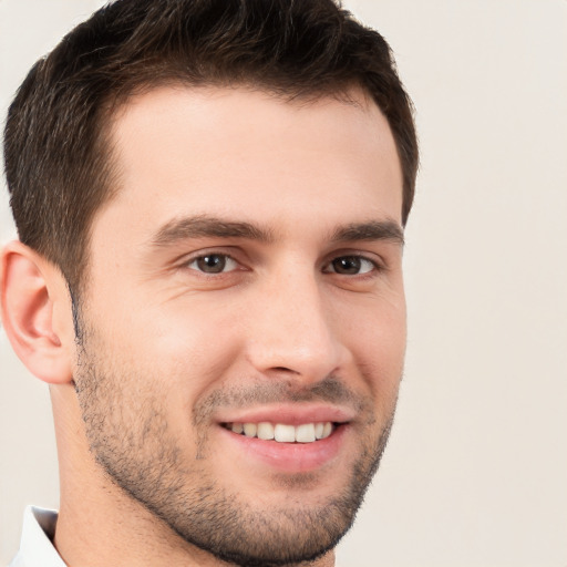 Joyful white young-adult male with short  brown hair and brown eyes