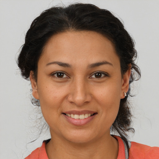 Joyful white adult female with medium  brown hair and brown eyes