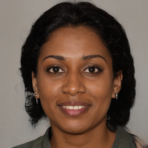 Joyful black young-adult female with medium  black hair and brown eyes