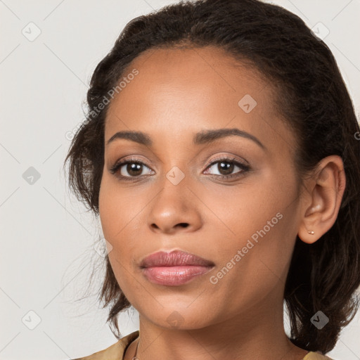 Joyful latino young-adult female with long  brown hair and brown eyes