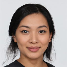 Joyful asian young-adult female with medium  black hair and brown eyes