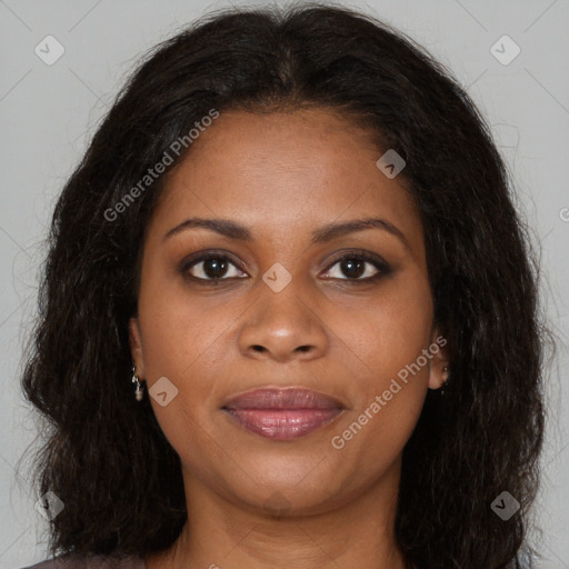 Joyful black young-adult female with long  brown hair and brown eyes