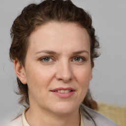 Joyful white young-adult female with medium  brown hair and blue eyes