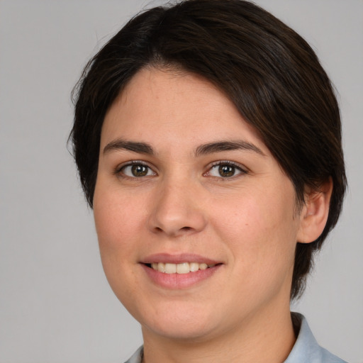 Joyful white young-adult female with medium  brown hair and brown eyes