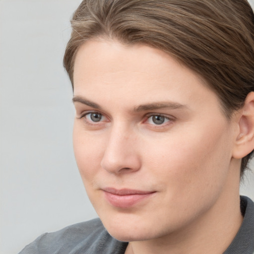 Joyful white young-adult female with short  brown hair and grey eyes